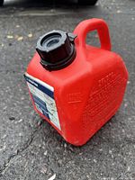 Front view of red gas can showing the cap and general condition.
