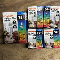 Photo showing one 75W Sylvania Daylight Plus Halogen bulb box and multiple 50W bulb boxes.