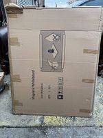 Photo of the cardboard packaging showing the product type 'Magnetic Whiteboard' and dimensions 36x48 inches with handling pictograms.