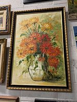 Full view of the oil painting showing flowers in a vase, signed and framed.