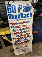 Box packaging showing brand name LYNX and shoe rack capacity of 50 pairs and shoe boxes.