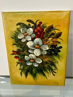 Full view of the signed floral oil on canvas painting showing white flowers, red berries, greenery, and yellow background.