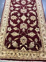 Full view of rug on concrete floor showing overall design