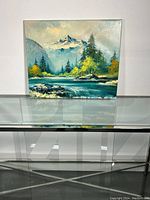 Full view of the oil painting showing the mountain landscape with a river and trees on canvas