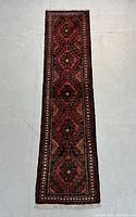 Full-length view of the runner rug laid flat on a gray surface