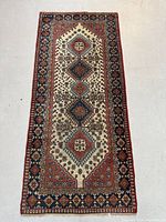 Full view of the hand knotted Persian Shiraz wool rug with multi medallion and floral geometric design.