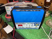 Front view of NAPA 15A battery charger showing LED display and charging settings.