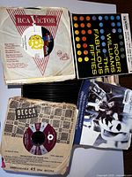 Top view of vinyl records in original sleeves showing RCA Victor and Decca Records labels, plus Roger Williams album cover