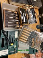 Overall view of woodworking tools including chisels, carving tool set, glue stapler, and smaller chisels