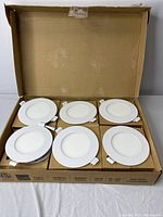 Open box showing six identical white 4-inch LED slim panel lights arranged neatly in packaging.