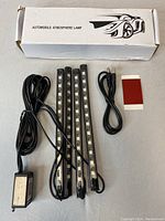 Full set including box, four LED light strips, control module, power cables and adhesive pad.