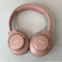 Front view of pink KVIDIO wireless over-ear headphones with visible branding on ear cups.