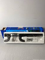 Overview of the car anti-theft lock inside its original packaging box, showing the foam holder and lock with dials visible.