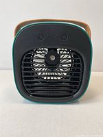 Front view of the desktop water cooling fan showing the fan blades and black grill with control buttons on top.