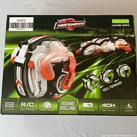 Photo of the Hot Engine toy box showing brand, product name, features such as R/C, round rolling, tumble, 2.4 GHz, 4CH, electric, with visual branding and sport design.