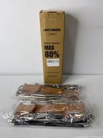 Two pants hangers and their cardboard box, the box states 'Pants Hanger 2 Pack' and 'Space Saving Max 80%'