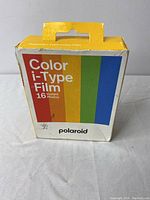 Polaroid I-Type Color Film box showing front side with colorful vertical stripes and Polaroid branding.