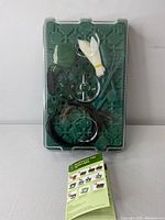 Top-down view of the sealed seed starter tray with components arranged inside and instruction leaflet visible beneath the clear lid.