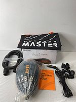 Full kit of the SUP electric air pump laid out, showing the pump, hose, power cord, multiple nozzles, user manual, and carry bag on a white surface.