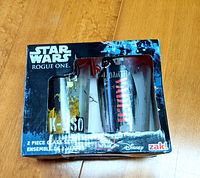Two-piece Star Wars Rogue One themed glass set in original packaging showing K-2SO and Darth Vader graphics.