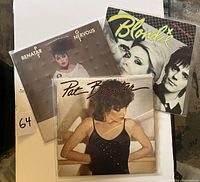 Photo showing three vinyl albums: two by Pat Benatar, one by Blondie with covers visible.