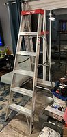 Front angled view of the 6 ft aluminum step ladder showing brand logo and structure.