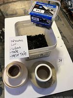 Large container of 6x1 1/4 inch drywall screws, smaller container of 6x2 inch screws, and two rolls of drywall tape (white paper and mesh)