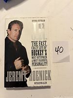 Photo of the front cover of the Jeremy Roenick book with a note showing number 40 nearby.