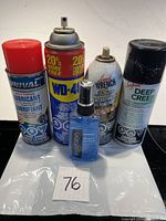 Five aerosol and spray lubricant and penetrating oil products from various brands.