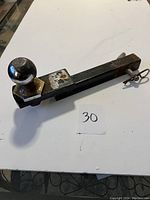 Receiver hitch insert showing the full length of the hitch with towing ball attached and securing pin in place.