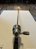 Full view of fishing rod with mounted reel, showing reel front with Ugly Cast branding