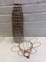 Stacked lightbulb cages showing the shape and vintage copper/brass wire finish