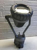Front angle view of the Appleton industrial light showing the metal arms, lens housing, and base.