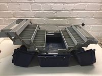 Open view of the tackle box showing internal multi-tier compartment trays and pouches.