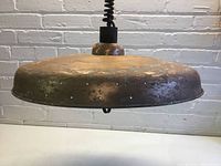 Copper pendant light shade with visible wear and finish damage.