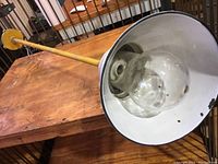 Industrial pendant light with white enamel shade, original glass globe, yellow pipe and mounting plate.