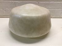 Top and side view of aged milk glass schoolhouse globe light shade, showing dome shape and patina.