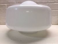 White milk glass schoolhouse globe light shade front profile showing rounded dome shape and opaque finish.