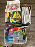 View of lot with adult coloring books, Crayola crayons and multiple boxes of colored pencils and art supplies