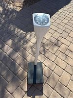 Full view of the Health o Meter analog floor scale showing the white frame, black foot platform, and the large dial on top.