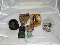 Overview of all Southwest themed items including pottery, Kachina dolls under glass dome, carved stone mushroom, and pottery shards.