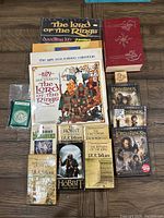 Photo showing all included items: books, calendars, DVDs, doodle kit, and more, arranged on wood floor