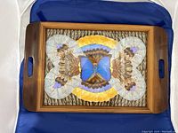 Top view of wooden tray showing butterfly design with wooden handles visible on each side.