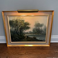Full front view of the framed painting with accent light turned on illustrating the artwork and frame condition.