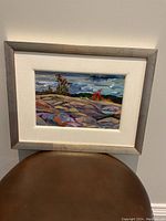 Front view of framed acrylic painting showing vibrant outdoor rocky landscape with cloudy sky and some trees.