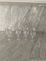 Group photo showing 10 Cristal D'Arques crystal wine glasses arranged on a marble surface, highlighting clarity and uniform design.