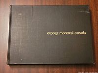 Front cover of the book with the title 'expo67 montréal canada' embossed in gold on a dark textured hardcover.