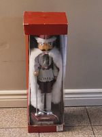 Front view of large Bombay nutcracker in original clear-front red box showing details of the figure's clothing and accessories.