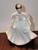 Front view of Royal Doulton Angela HN 2389 figurine showing the woman's face, upper body, and flowing gown in glossy white porcelain with smooth finish.