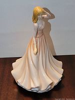 Front-angle view of the Royal Doulton Christina porcelain figurine showing detailed facial features, upper lace-patterned dress, and full flowing skirt.